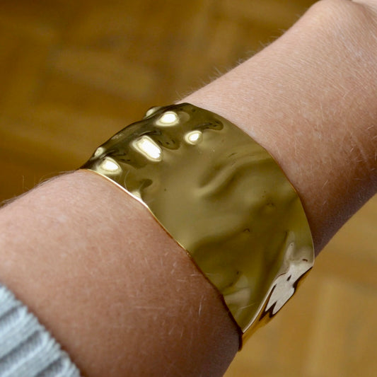 Pulsera o brazalete ajustable y ancho resistente al agua. Está confeccionado en acero inoxidable dorado. Es perfecto para looks de invitada a boda o fiestas de noche boho. Gold plated stainless Steel adjustable waterproof bracelet.