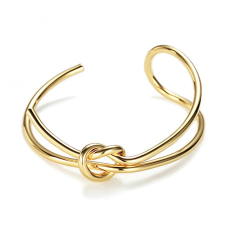 pulsera o brazalete rígido dorado con nudo