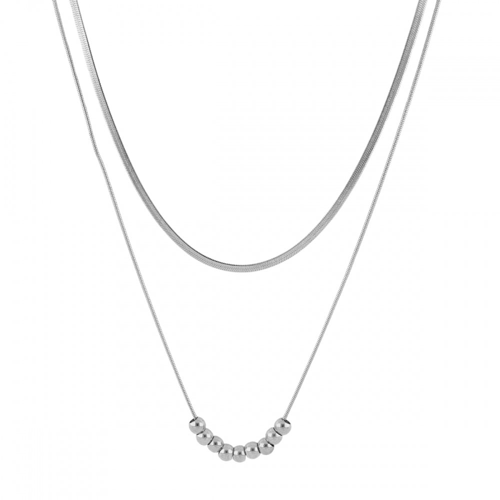 Collar boho de dos cadenas juntas, una de bolitas y otra de escama herringbone. Es de acero hipoalergénicos resistente al agua. Son 2 collares en 1.