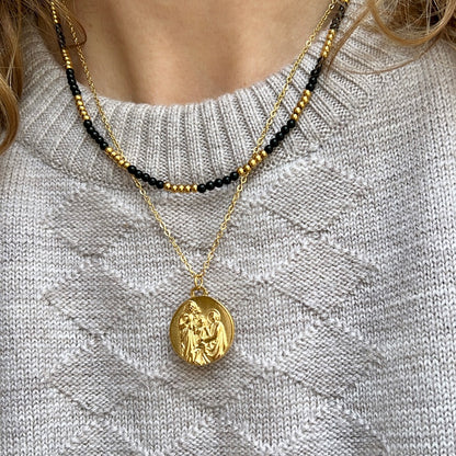 colgante con medalla de la sagrada familia. El material es acero inoxidable, quirúrgico e hipoalergénico color oro. Es un collar religioso católico perfecto para regalar en una primera comunión a niños y niñas. 