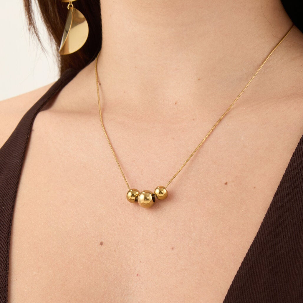 gargantilla boho para adolescente o mujer joven que lleve escote en v o escote pronunciado. es de cadena con bolas colgantes. ideal para looks de noche o de fiesta. Es de acero hipoalergénico dorado o plateado y resistente al agua
