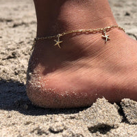 tobillera de plata de ley con baño de oro y 6 estrellas de mar. Gold plated silver anklet with starfish charms.